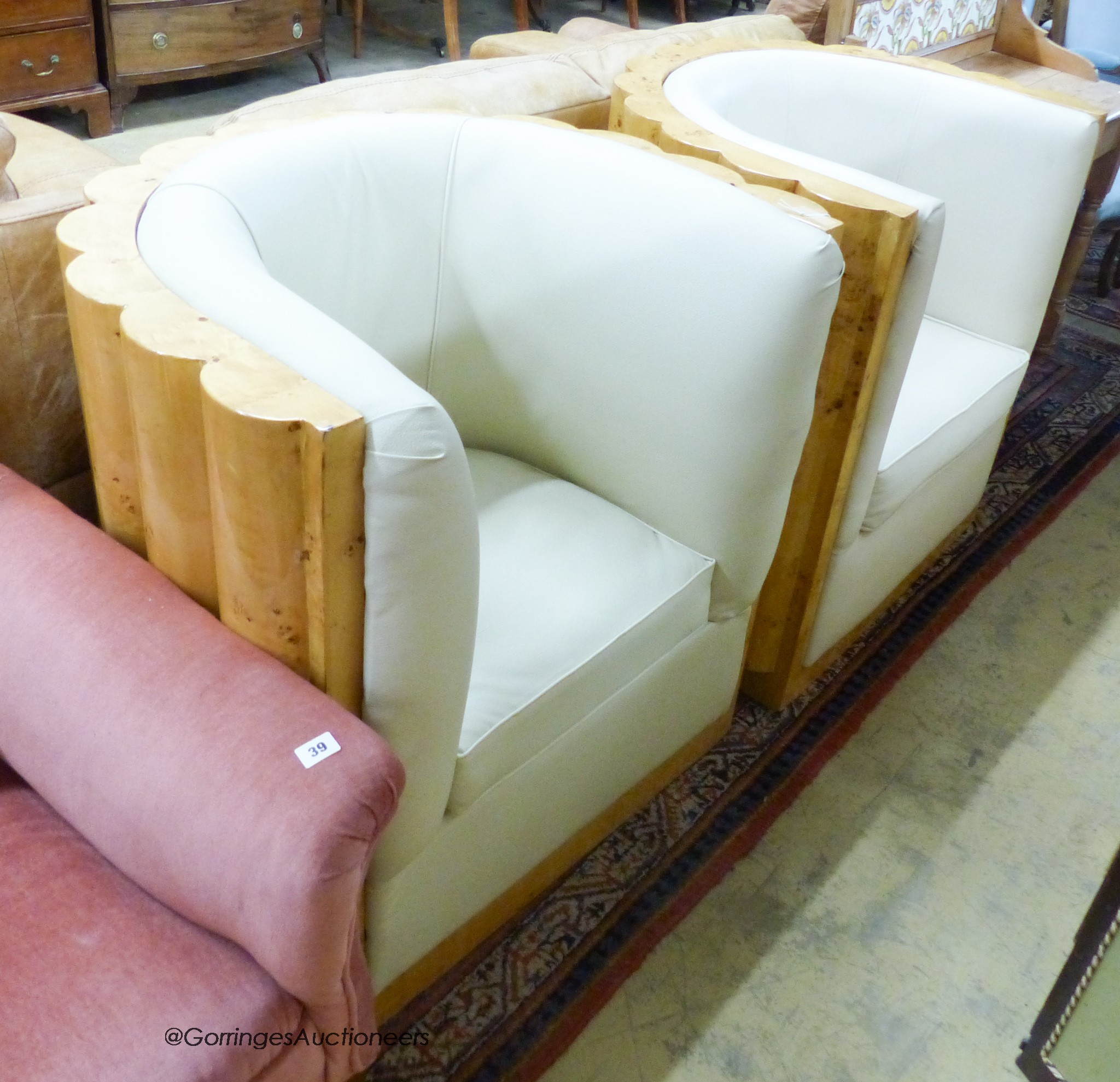 A pair of Art Deco style tub framed cream leather and maple chairs, width 84cm, depth 66cm, height 85cm